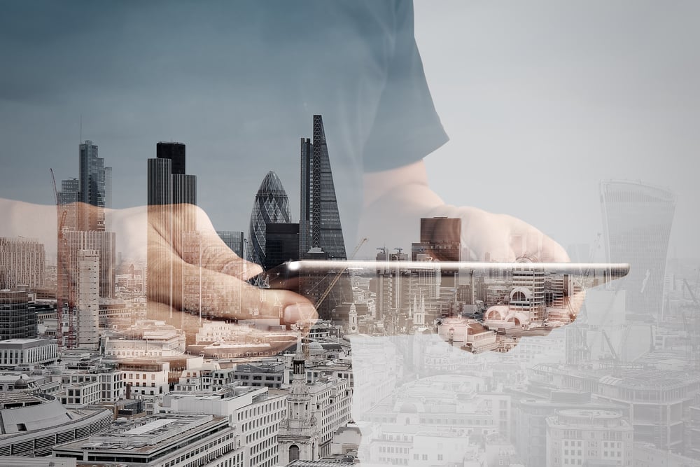 Double exposure of success businessman using digital tablet with london building and social media diagram-1